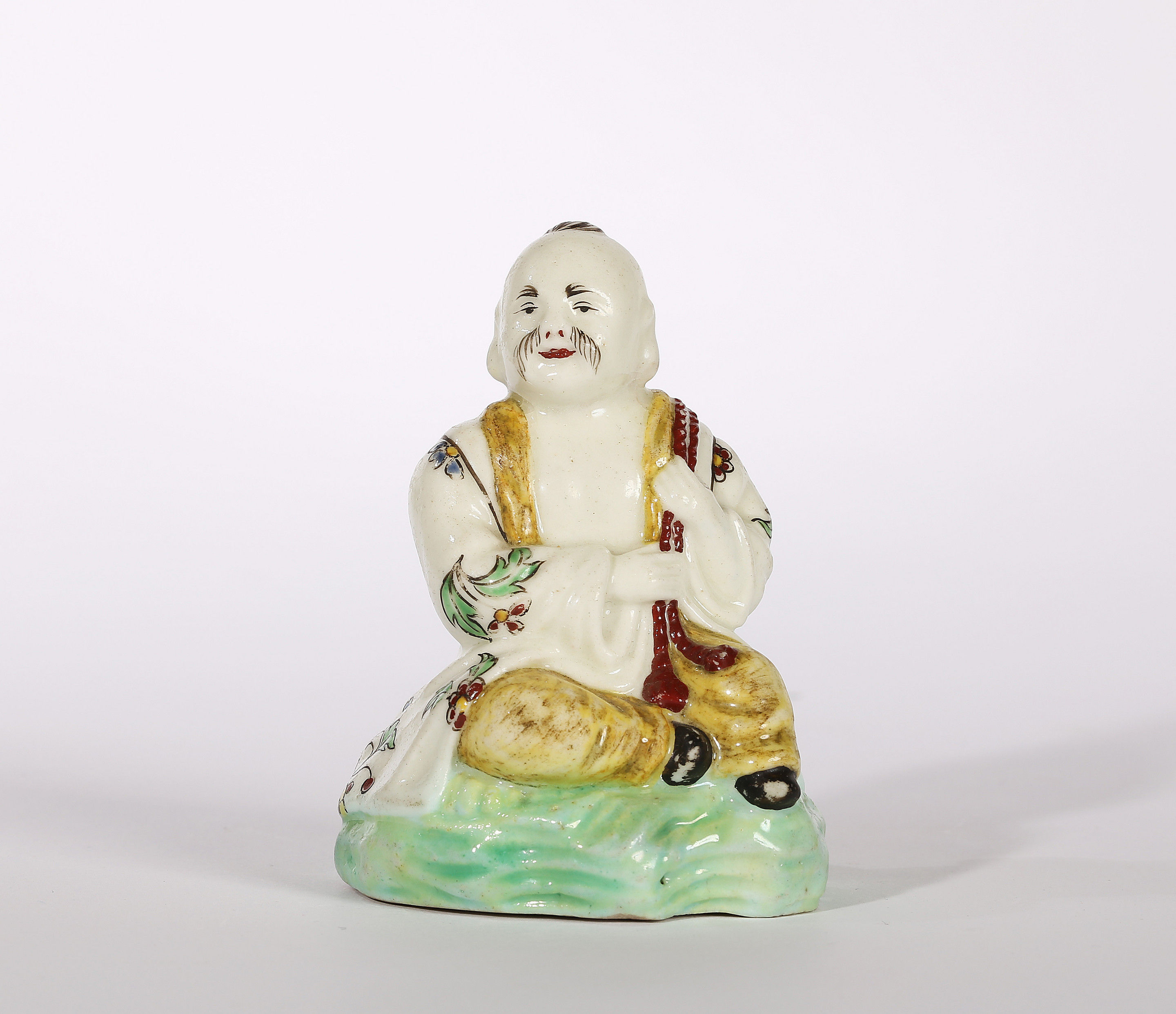 A Villeroy Figure of a Seated Chinese Man