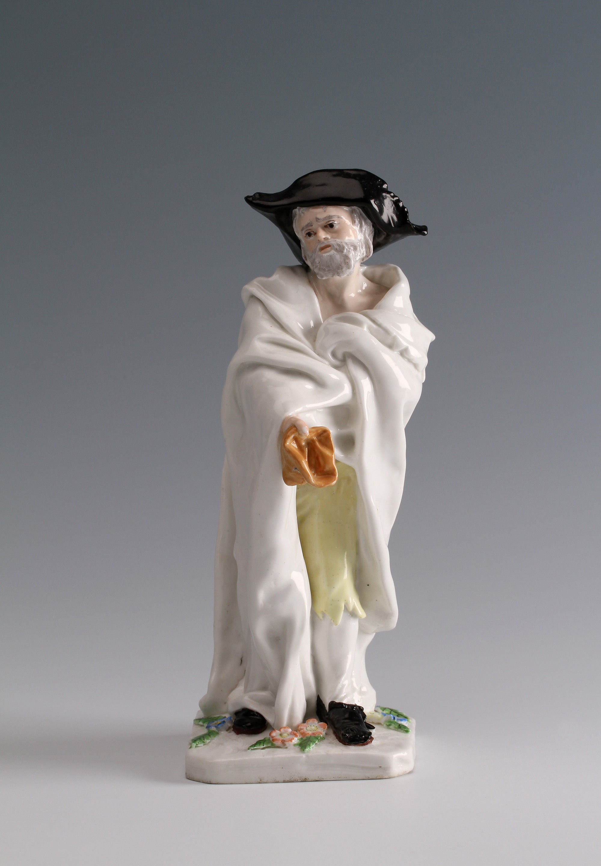 A Chelsea figure of an 'Italian Beggar' modelled by Joseph Willems